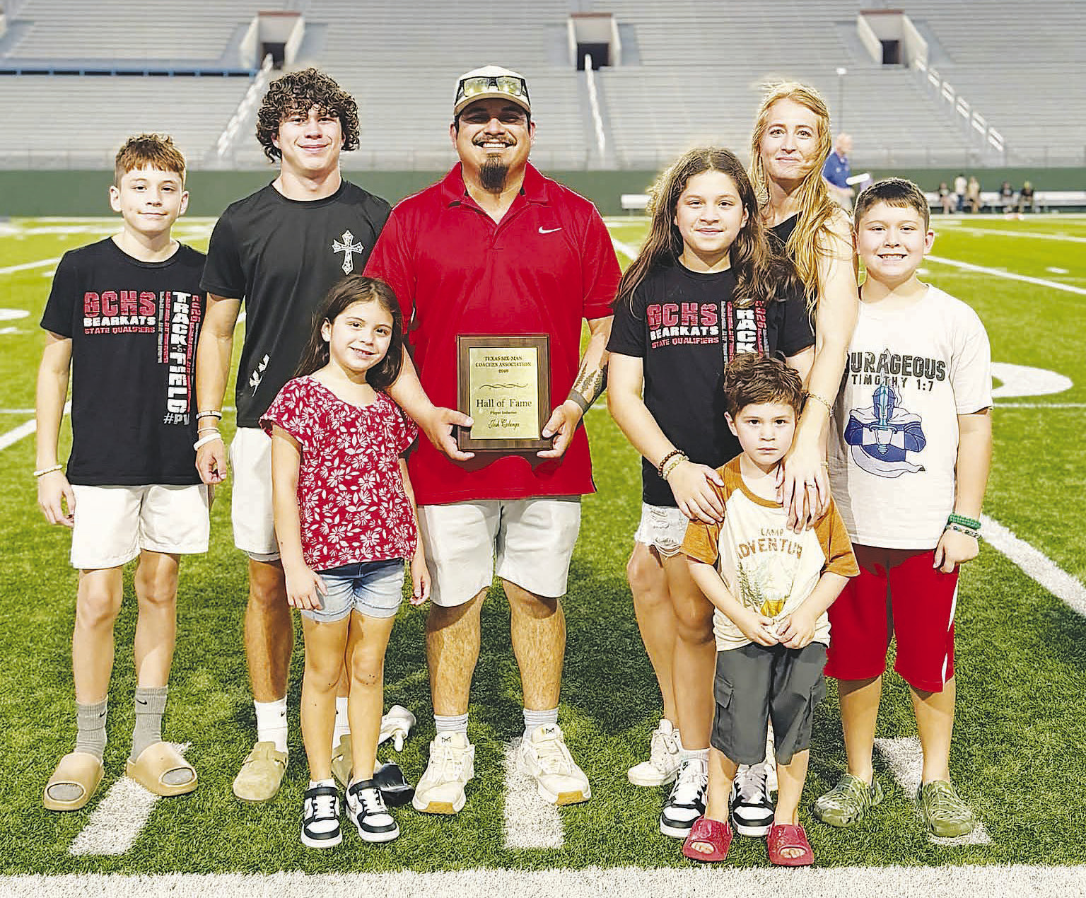 Josh Colunga stands with his wife and children after receiving his Texas Six-Man Coaches Association Hall of Fame award in Wichita Falls. Colunga, a 2011 Garden City graduate and former running back, was part of the Bearkats’ back-to-back state championship teams in 2009 and 2010.
