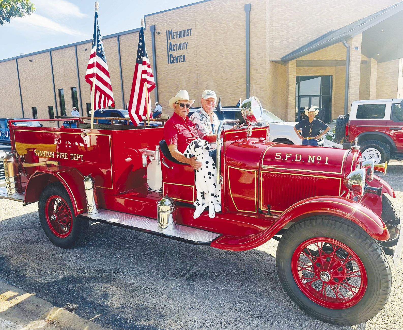 Bob Wilson, interim president of the Martin County Historical Society, drives Martin County’s restored first fire truck through downtown Stanton during the centennial celebration parade in July. Mike Black, the project’s largest donor, rides in the passenger seat.