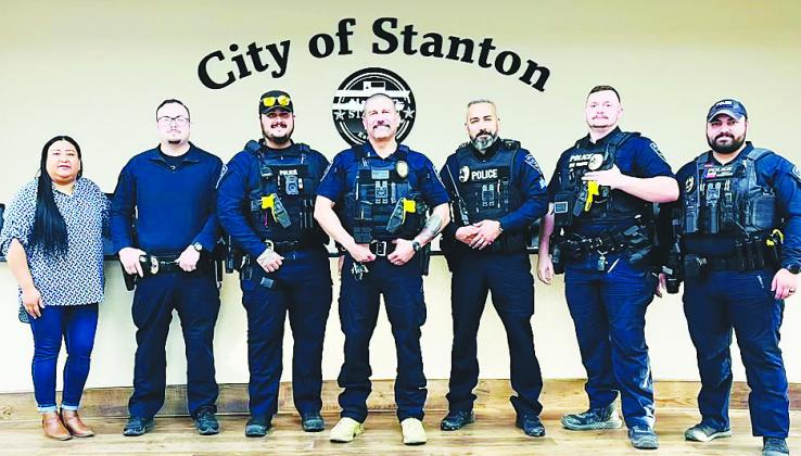The Stanton Police Department's officers and Municipal Clerk Maribel Samora pose for a group photo after the Stanton City Council officially appointed Dustin Franco (center) as police chief. Franco filled four vacancies after taking over as interim chief in January, bringing the department to full staffing.