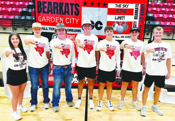 Members of the Garden City Bearkats’ state championship teams proudly show off their new state rings during Meet the Bearkats earlier this month. The rings serve as a lasting reminder of the team’s outstanding accomplishments and the hard work, dedication and teamwork that went into bringing home a state titles.