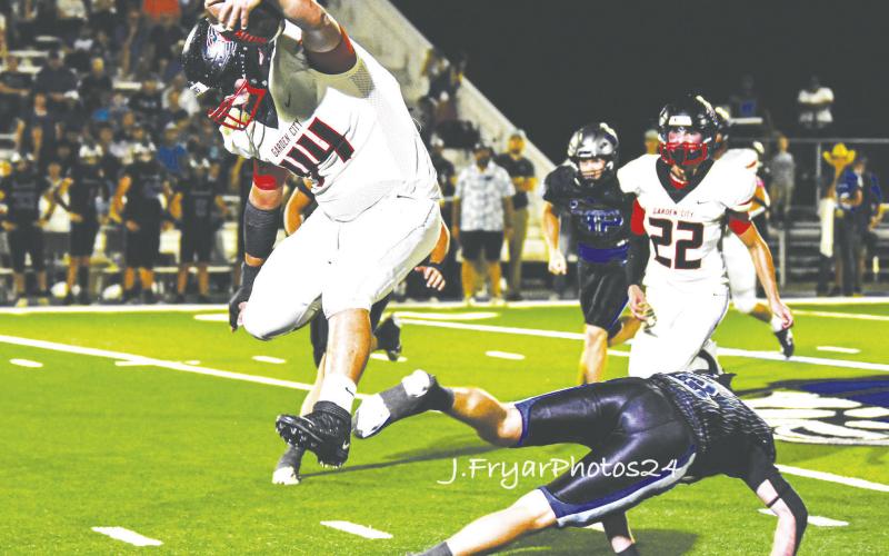 Garden City’s Roberto Almazan (44) hurdles a Westbrook Wildcat defender during one of the three receptions. photo by Janie Fryar