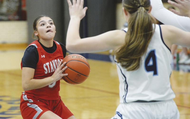 Stanton point guard lauren Alvizo lines up a three point shot against the Greenwood Rangerettes defense. The Lady Buffs host the Hooptown Tournament this weekend.