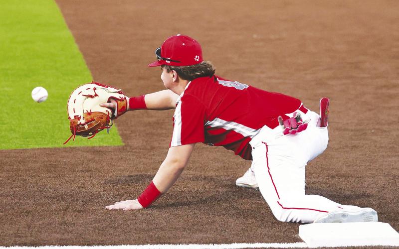 Stanton first baseman Kolton Bruner with the big stretch to get the out at first. photo provided by D’Lee Cook Photography