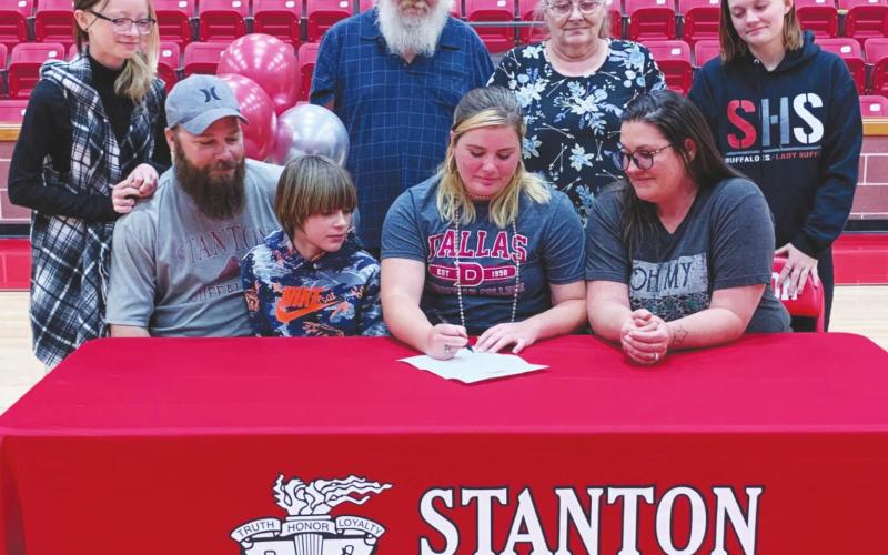 Trinity Johnson is surrounded by her family as she signs her letter of intent to play softball at Dallas Christian College. Left to Right are: her sister Kallie O’Neal, father Landon O’Neal, brother Charles O’Neal, grandfather Casey Nassett, grandmother Virginia Nassett, mother Misty O’Neal, and sister Katlynn O’Neal.