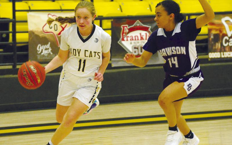 Grady guard Reagan Dennis flies past a Dawson Dragons defender during district action earlier this season. The Wildcats plays Whitharral for bi-district next week.