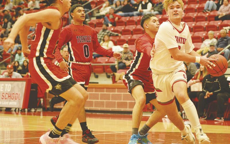 Stanton guard Nic Haas blows past a double team and scores a contested lay-up against the Tornillo Coyotes last week. Haas finished the game with eight points and the Buffaloes won the game 46-41.