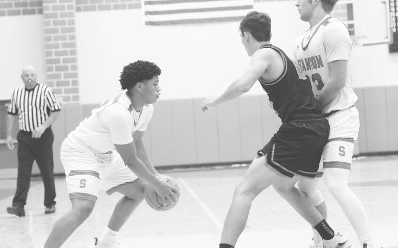 Jake Benedict sets a screen for teammate Javion Thompson during action against Garden City earlier this year in Stanton.