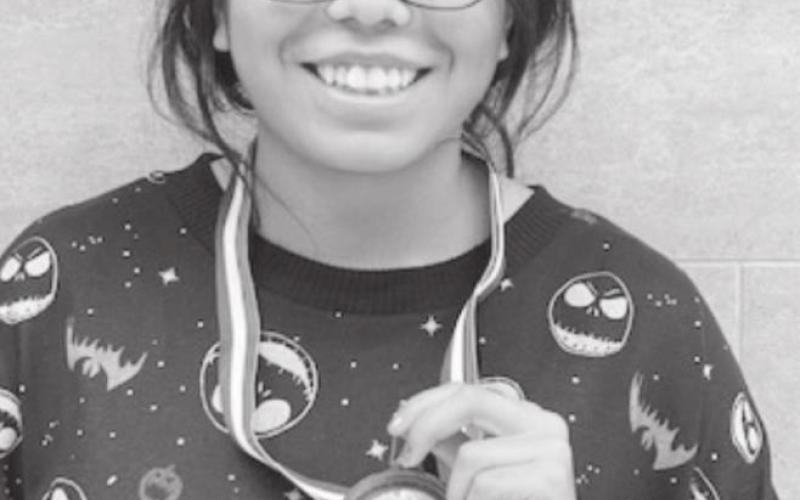 Yareli Rodriguez shows off her third place medal from Saturday’s race in Lubbock.