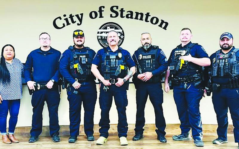 The Stanton Police Department's officers and Municipal Clerk Maribel Samora pose for a group photo after the Stanton City Council officially appointed Dustin Franco (center) as police chief. Franco filled four vacancies after taking over as interim chief in January, bringing the department to full staffing.