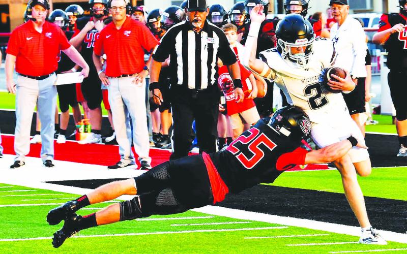 Garden City defensive back Brody Walts (25) makes a diving stop on a Water Valley Wildcat during the season opener last Thursday. photo by Janie Fryar