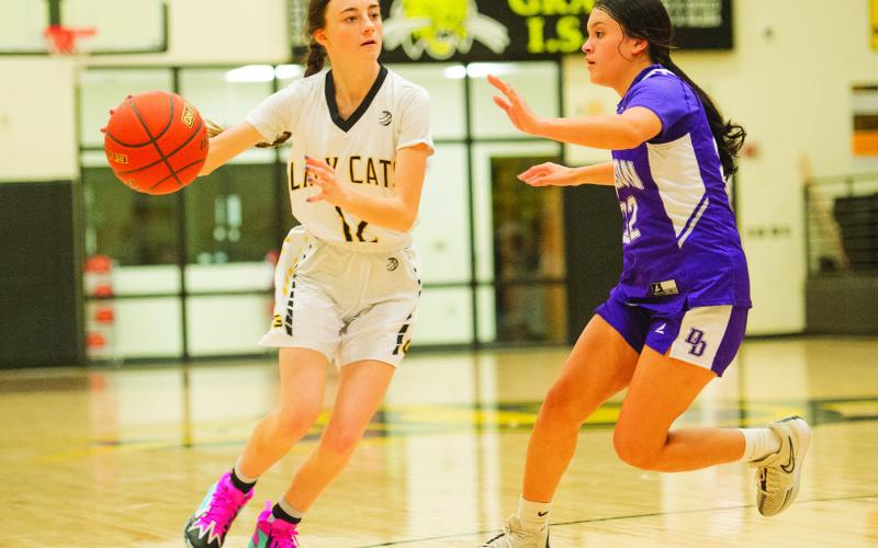 Grady’s Rylan o’Donnell drives past a Dawson Lady Dragon defender during district action earlier this season.