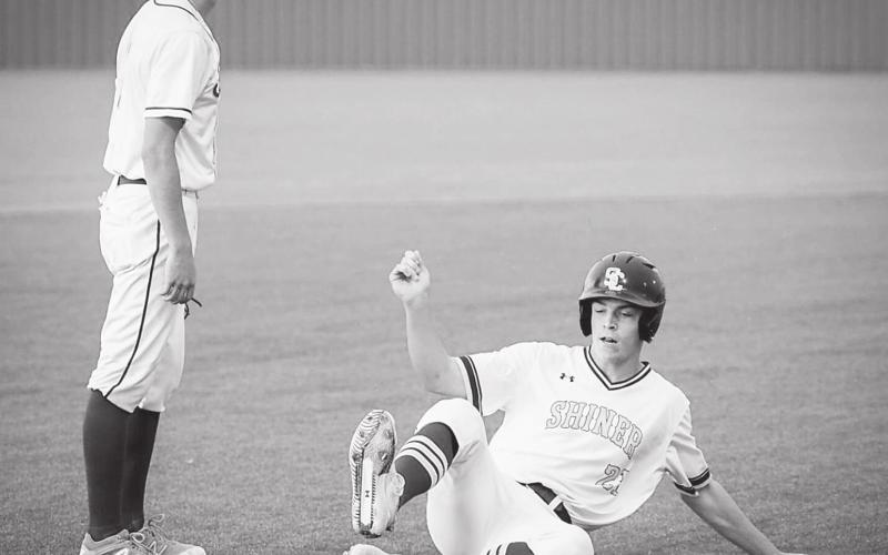 Shiner sophomore Ryan Peterson slides into third base during the regional championship victory over Sabinal last week in Jourdanton. by Howard Esse