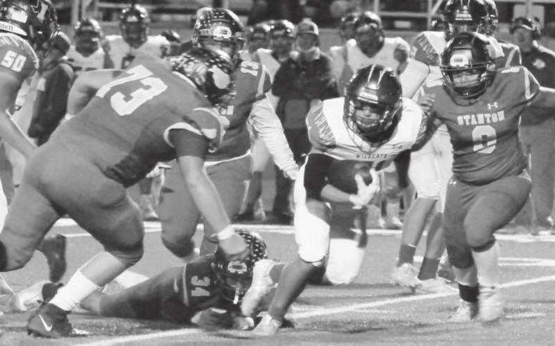A herd of Buffaloes - Payden Alberts (73), Marco Armendarez (13), Hoyt Mims (34), Miguel Moreno (8) - tackle an Idalou Wildcat for a loss during last weeks game in Stanton.