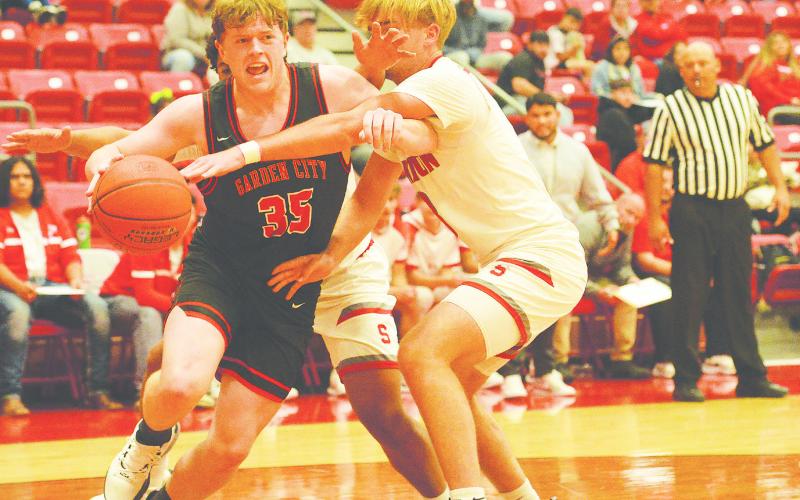 Garden City’s Jarett Fryar drives the baseline for a contested layup against Stanton’s Nic Haas earlier this season.