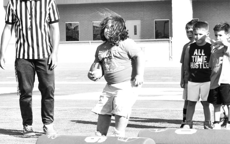 Coaches from the Norman Elite Football Camp taught the young players how to secure the football while working on lateral movements.