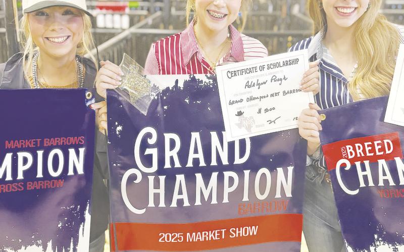 Kailynn Peugh (right) and Adalynn Peugh (center) both showed Market Barrows at the Texas National Stockshow in Witchita Falls. Adalynn show the Grand Champion Barrow and Kailynn showed the Champion York. Together the sisters won $10,000 worth of scholarships.