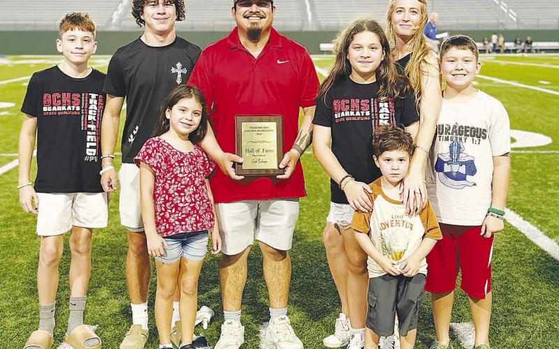 Josh Colunga stands with his wife and children after receiving his Texas Six-Man Coaches Association Hall of Fame award in Wichita Falls. Colunga, a 2011 Garden City graduate and former running back, was part of the Bearkats’ back-to-back state championship teams in 2009 and 2010.