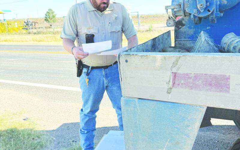 Martin County deputy Chase Stiles looks over some environmental standards during a traffic stop in Martin County. Stiles is looking to make an impact cleaning up the county