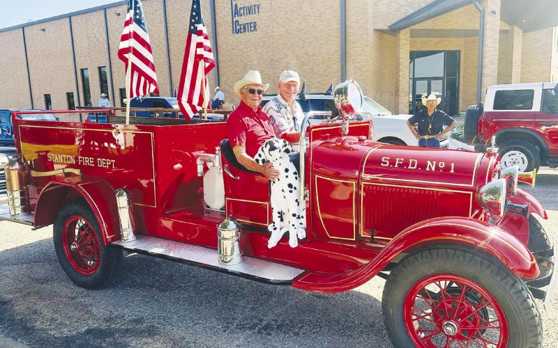Bob Wilson, interim president of the Martin County Historical Society, drives Martin County’s restored first fire truck through downtown Stanton during the centennial celebration parade in July. Mike Black, the project’s largest donor, rides in the passenger seat.