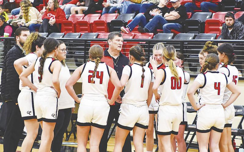 Garden City coach Thomas Clay spends a timeout to discuss strategy with his team. photo by Janie Fryar