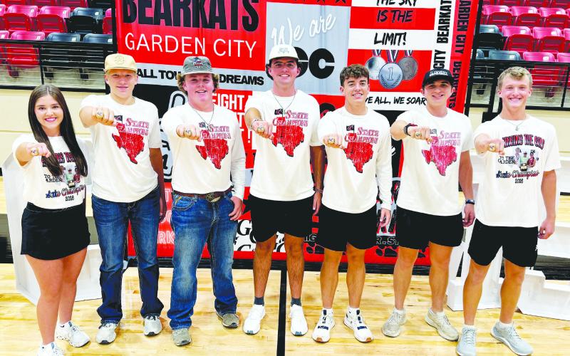 Members of the Garden City Bearkats’ state championship teams proudly show off their new state rings during Meet the Bearkats earlier this month. The rings serve as a lasting reminder of the team’s outstanding accomplishments and the hard work, dedication and teamwork that went into bringing home a state titles.