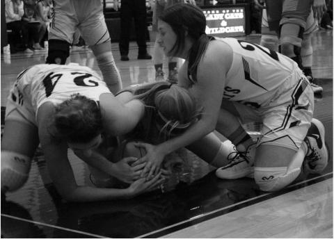 Grady’s Haydn Burge and Ashely Hill battle a Borden County Coyote for a loose ball during district action Tuesday night in Grady.