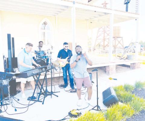 Albert Hall serenaded the crowd at the 1884 Plaza during the Farmet Market on Tuesday.