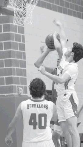 Jaxson Lindell guards the basket with a fierce block on a Coahoma Bulldog during district action in Stanton.