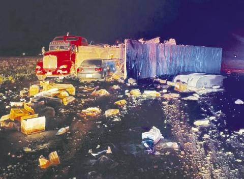 After two semis collided on Hwy 349 and CR 5100 and made a massive mess, another car drove through the debris. There were no injuries reported.