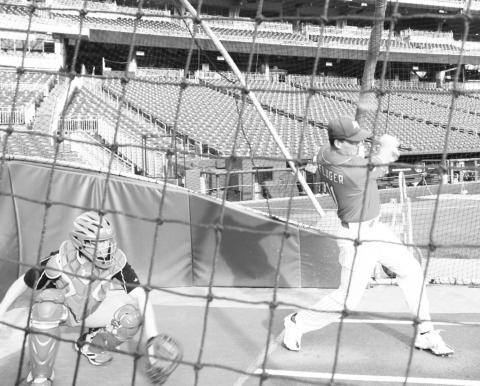 Congressman August Pfluger takes batting practice before the annual Congressional Baseball Game.