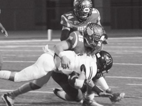 Tyler Benedict (15) and Eddie Wittenbarger (24) bring down an Abernathy Antelope during district action last week in Stanton.