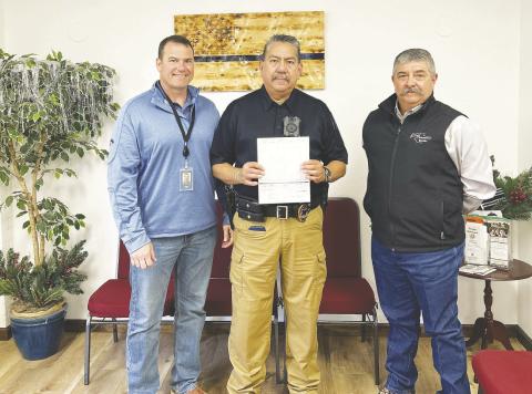 Pioneer Natural Resources donated ten thousand dollars to the Stanton Police Department. Robert Guillot and Jorge Hinojosa, both with the Pioneer Security Department are shown here presenting the check to Chief of Police, J.B. Morales. The money will go to obtaining equipment for the Police Department.