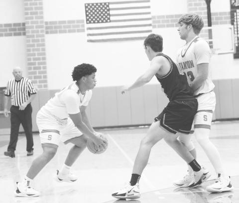 Jake Benedict sets a screen for teammate Javion Thompson during action against Garden City earlier this year in Stanton.