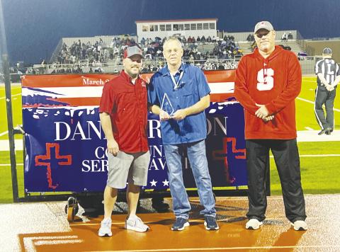 Brandon Ireton and Stanton High School Principal Drew Daniel presented Brad Holland with the Danny Ireton Community Service Award for his outstanding service to Stanton and Martin County.