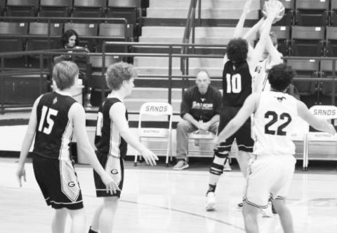 Grady’, Blaise Warren (10), Hunter McAnally (12), and Austin Snider (15) play defense during the Wildcats victory over Sands Tuesday night in Ackerly.