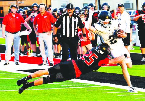 Garden City defensive back Brody Walts (25) makes a diving stop on a Water Valley Wildcat during the season opener last Thursday. photo by Janie Fryar