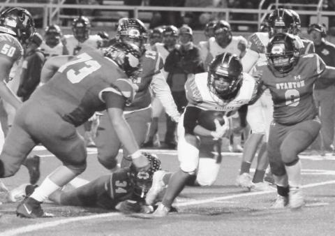 A herd of Buffaloes - Payden Alberts (73), Marco Armendarez (13), Hoyt Mims (34), Miguel Moreno (8) - tackle an Idalou Wildcat for a loss during last weeks game in Stanton.