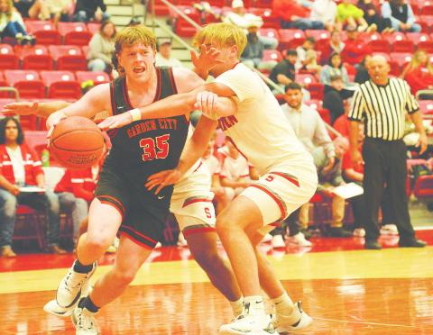 Garden City’s Jarett Fryar drives the baseline for a contested layup against Stanton’s Nic Haas earlier this season.
