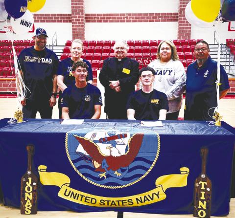 Last Thursday at Stanton High School, seniors Jonas Rivas (left) and Valentino Rodriguez (right) signed their letters of intent to join the Navy. Both will be leaving to Navy boot camp after graduation. They are pictured with their parents and Father Michael Rodriguez.