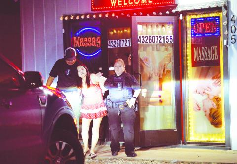 Officers with the Stanton Police Department arrest Guijie Han for prostituion at her place of business on Apr. 30 in Stanton.