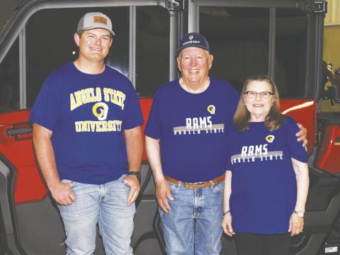 Garden City graduate Brody Hoelscher stands with Glasscock County 4-H shooting coach Fred Chaney and Chaney’s wife. The three sport Angelo State University shirts, where Hoelscher earned a scholarship last year to join the shotgun sports team. Hoelscher credits Chaney for helping him reach that goal.