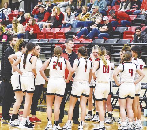 Garden City coach Thomas Clay spends a timeout to discuss strategy with his team. photo by Janie Fryar