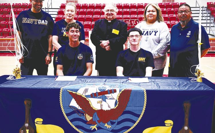 Last Thursday at Stanton High School, seniors Jonas Rivas (left) and Valentino Rodriguez (right) signed their letters of intent to join the Navy. Both will be leaving to Navy boot camp after graduation. They are pictured with their parents and Father Michael Rodriguez.