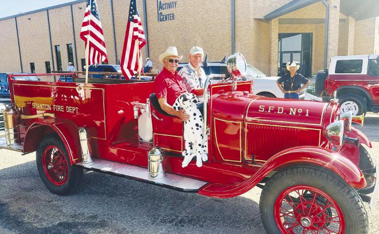 Bob Wilson, interim president of the Martin County Historical Society, drives Martin County’s restored first fire truck through downtown Stanton during the centennial celebration parade in July. Mike Black, the project’s largest donor, rides in the passenger seat.