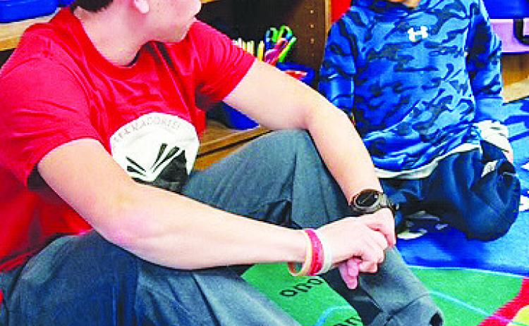 A Garden City High School senior chats with a second grader as the two get to know each other through the new Bearkat Buddies program.